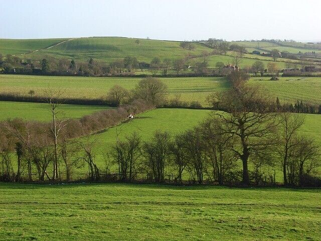Pastures, Quainton A view across fields towards Denham where some of the building can just be seen. In the background is Denham Hill.
