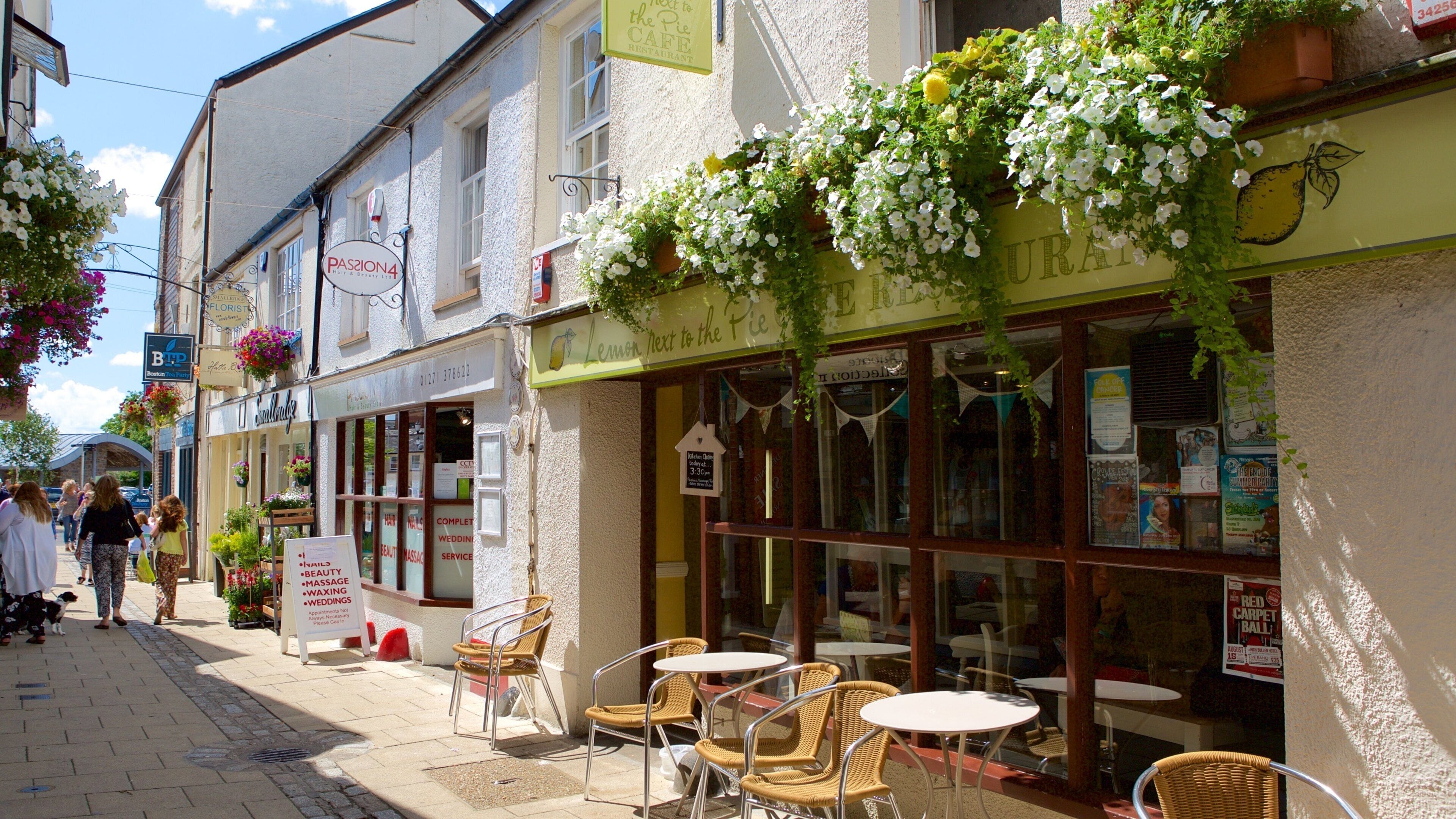 A street with outdoor seating, a cafe, and a florist.
