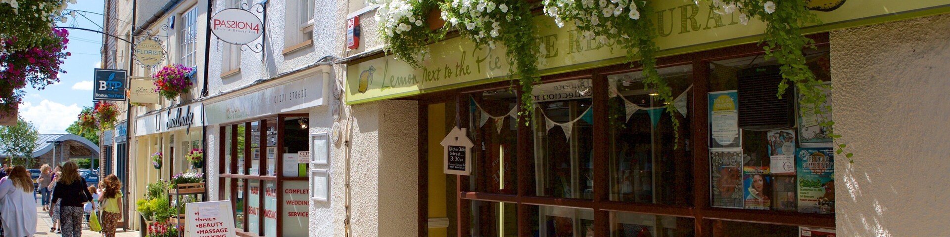 A street with outdoor seating, a cafe, and a florist.