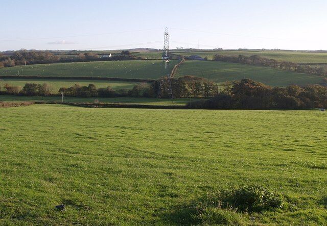 New Kennacott. Taken from the same spot as 600856, looking across the valley to the south of Newton Tracey to buildings at Kennacott. New Kennacott is directly behind the pylon; the house at West Kennacott, to its left, straddles with gridline into SS5326.