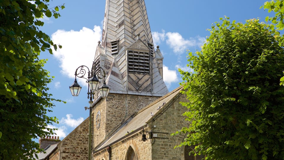A church with a tall, pointed steeple and a clock on the tower.