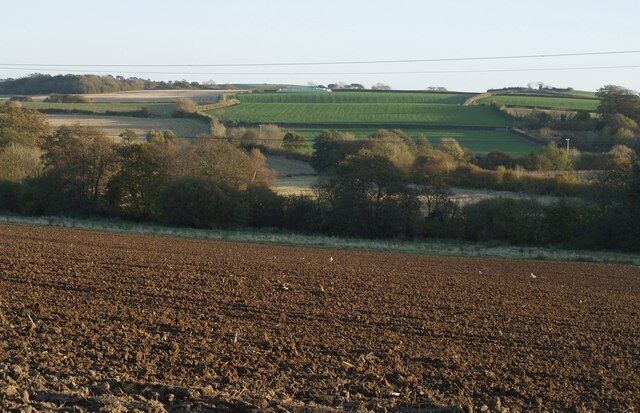 Countryside east of Grabbishaw. Grabbishaw is among the trees on the extreme right. This is a view across the field being drilled in 599139 and the valley also shown in 600256.
