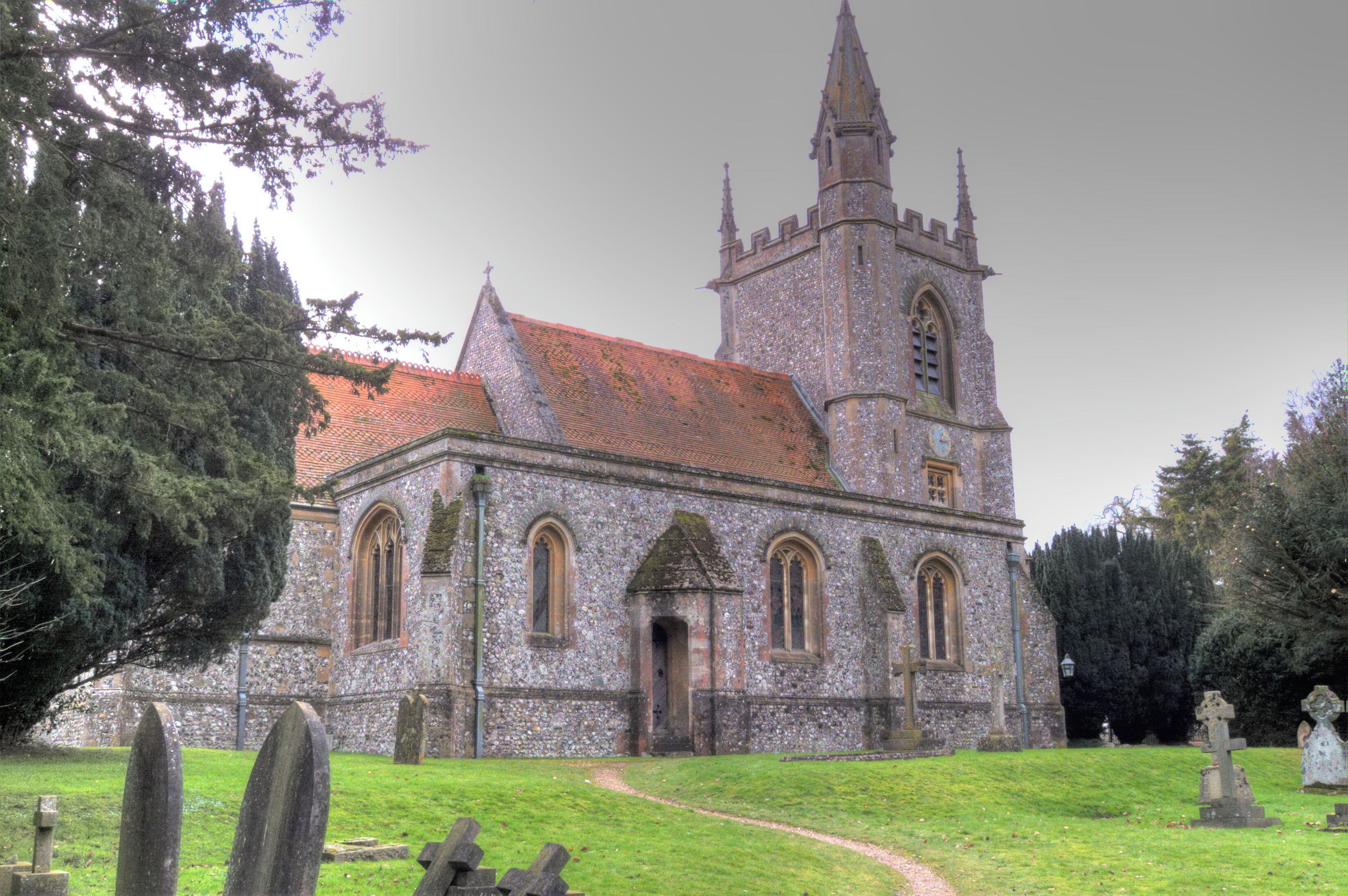 A historic church with a tall spire and a stone facade.