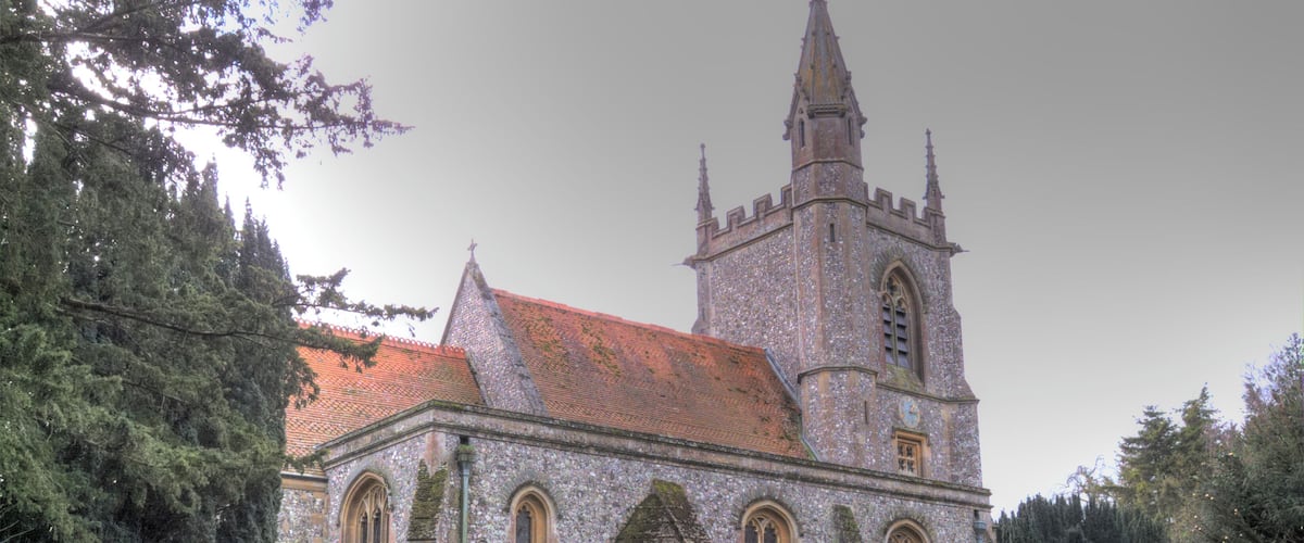 A historic church with a tall spire and a stone facade.