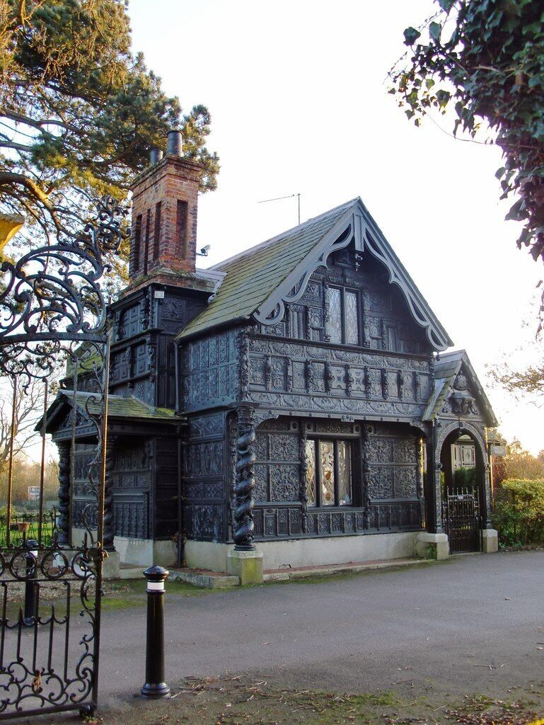 A large, ornate Victorian-style house with intricate woodwork and a prominent chimney.