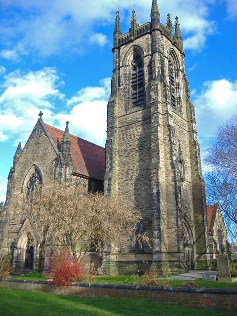 A historic church with a tall tower and arched windows.