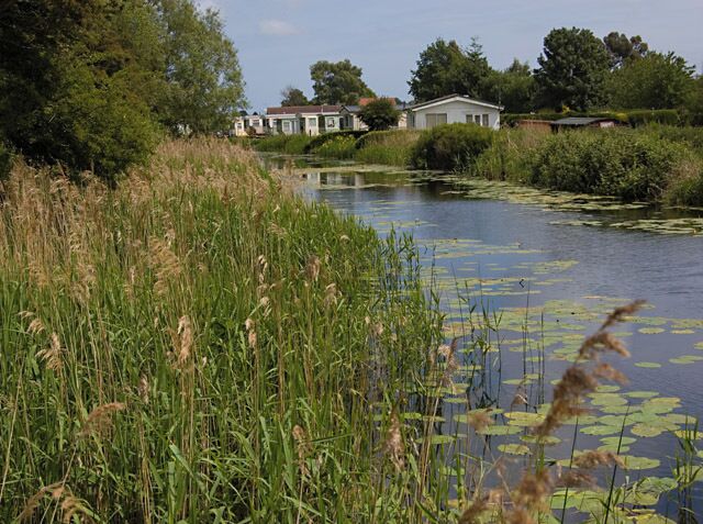 Leven Canal at Sandholme, Leven, East Riding of Yorkshire, England. Looking east along the canal towards the small caravan park on Sandholme Lane.