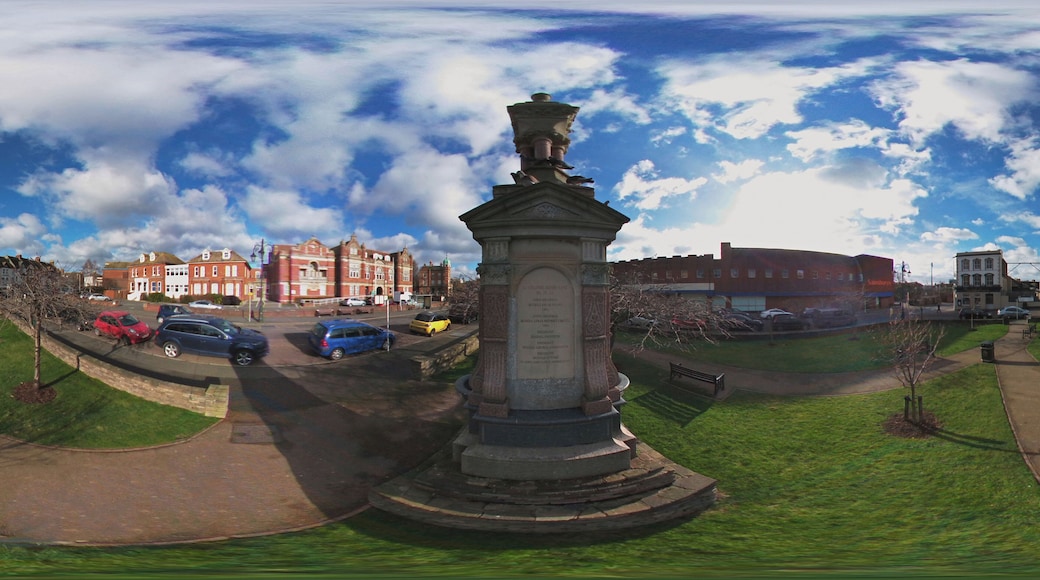 Opposite the town hall.