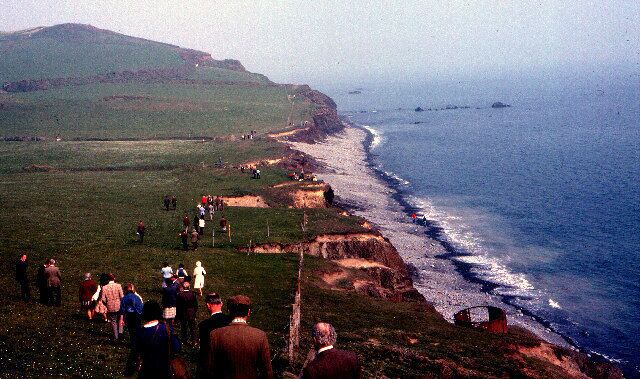 Opening the South West Coastal Footpath - Cornborough 1978. This view looking south towards Cornborough Cliff was taken on the occasion of the formal opening of this N Devon section of the SW coastal footpath, by the first Government Minister for Sport (Denis Howell, previously Minister for Drought!)hence the "mass ramble" on an otherwise normally quiet Sunday. The path follows the line of a dismantled railway trackbed that ran from Westward Ho! along the coast round the cliff then inland to Bideford. It's clearly marked on the current OS Explorer map