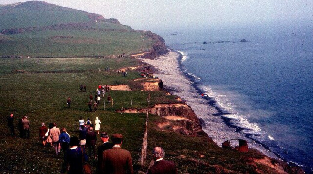 Opening the South West Coastal Footpath - Cornborough 1978. This view looking south towards Cornborough Cliff was taken on the occasion of the formal opening of this N Devon section of the SW coastal footpath, by the first Government Minister for Sport (Denis Howell, previously Minister for Drought!)hence the "mass ramble" on an otherwise normally quiet Sunday. The path follows the line of a dismantled railway trackbed that ran from Westward Ho! along the coast round the cliff then inland to Bideford. It's clearly marked on the current OS Explorer map