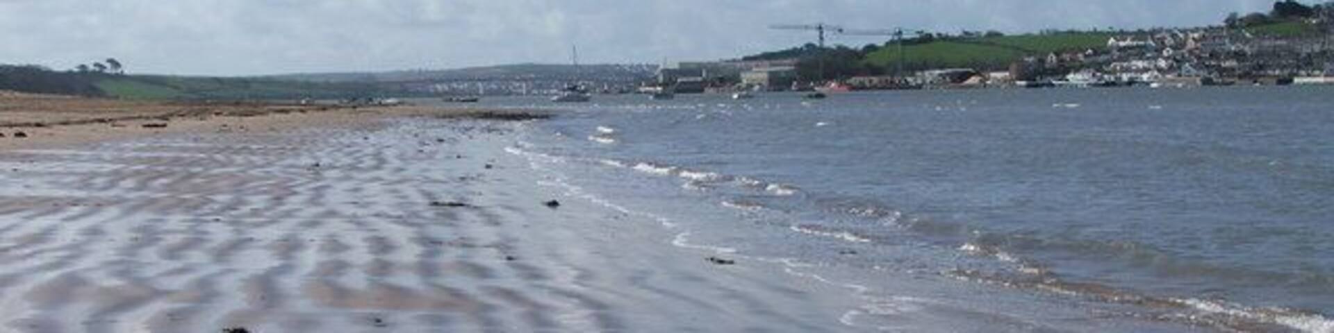 River torridge from Instow beach From the waters edge on Instow beach, looking up the Torridge with the cranes of Appledore ship yard on the opposite bank, and Bideford way off in the distance. The patterns in the sand seem to vary almost with every tide, sometimes flat, sometimes rippled, and sometimes ribboned, as here.
