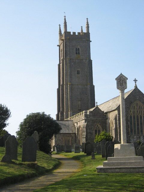 A church with a tall tower and a graveyard.