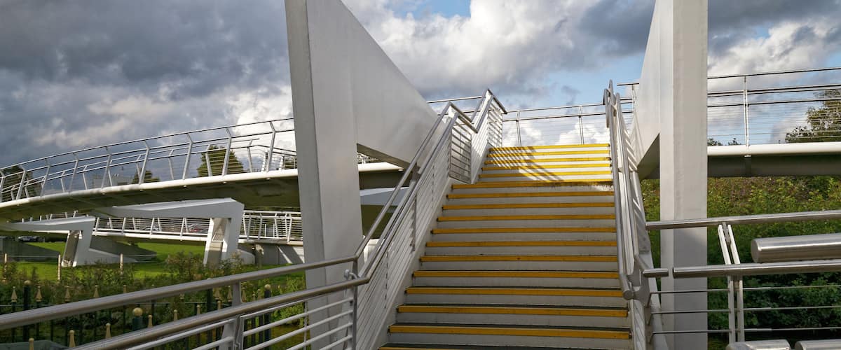A footbridge and steps from the Maltings on Southmill road, across the River Stort to the site of the previous British Rail Goods Yard at Bishop's Stortford, Hertfordshire, England. The bridge was completed in 2008. Software: RAW file lens-corrected, optimized and converted to JPEG with DxO OpticsPro 10 Elite, and likely further optimized and/or cropped and/or spun with Adobe Photoshop CS2.