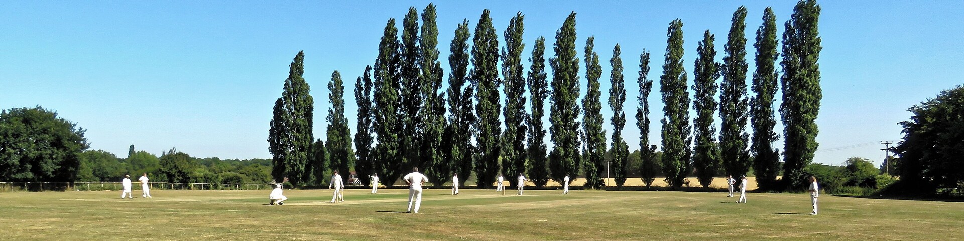 A public Herts and Essex League Saturday cricket game between Little Hallingbury CC and Thorley CC (Little Hallingbury batting), at Gaston Green, Little Hallingbury, Essex, England in 2018. Camera: Canon PowerShot SX60 HS Software: File lens-corrected, optimized, perhaps cropped, with DxO PhotoLab, and likely further optimized with Adobe Photoshop CS2.