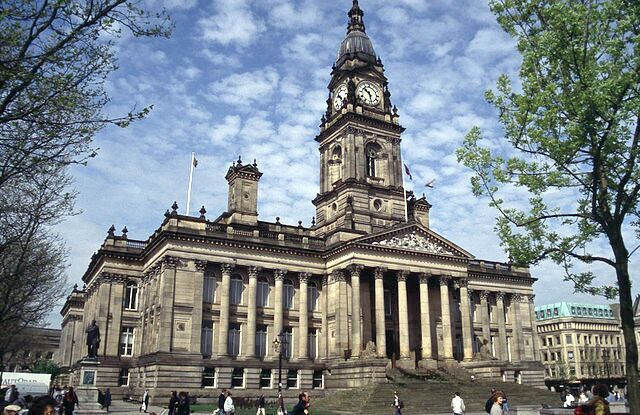 A large historic building with a clock tower and columns.