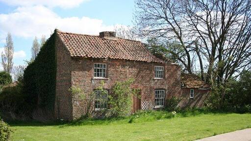 Derelict Cottage. Empty and derelict cottage in the garden of a modern house on Butterwick Road.