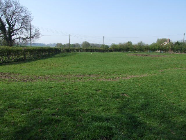 Field by the site of Miningsby church Church cottage can just be seen.