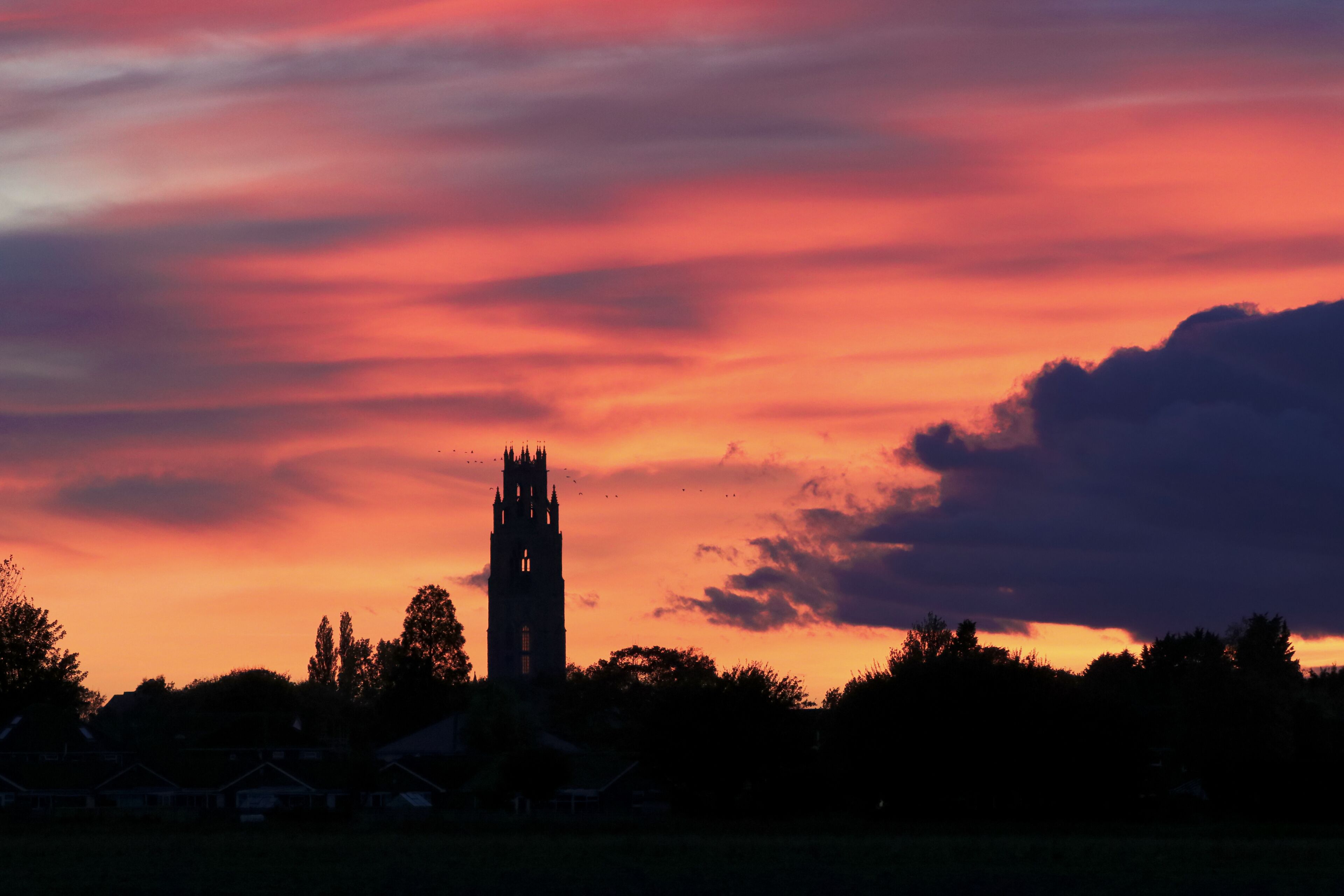 Sunset over Boston Stump tower. Silhouette with magnificent colourful clouds over the Lincolnshire church landmark.