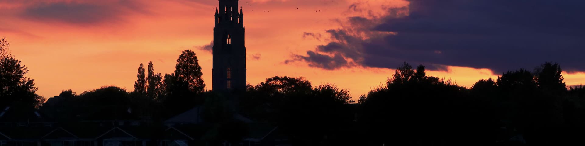 Sunset over Boston Stump tower. Silhouette with magnificent colourful clouds over the Lincolnshire church landmark.