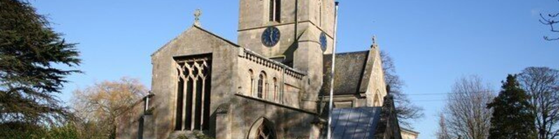 St Swithin's parish church, Bicker, Lincolnshire, seen from the southwest, showing the truncated end of the Norman nave. The nave originally extended further west but now endw with a square-headed window with rectilinear tracery.