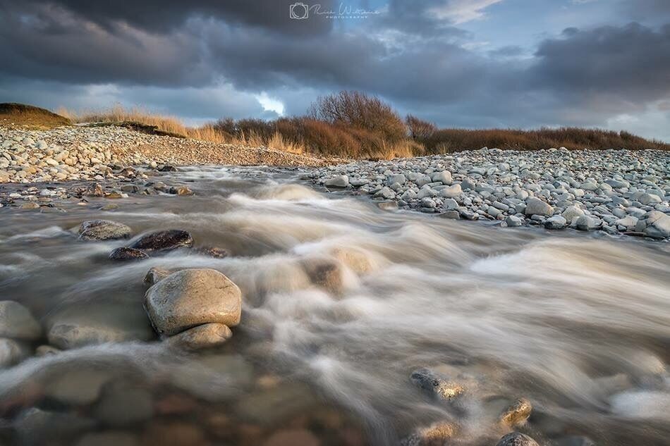 The river from kilve flowing out to sea after all the recent snowfall 