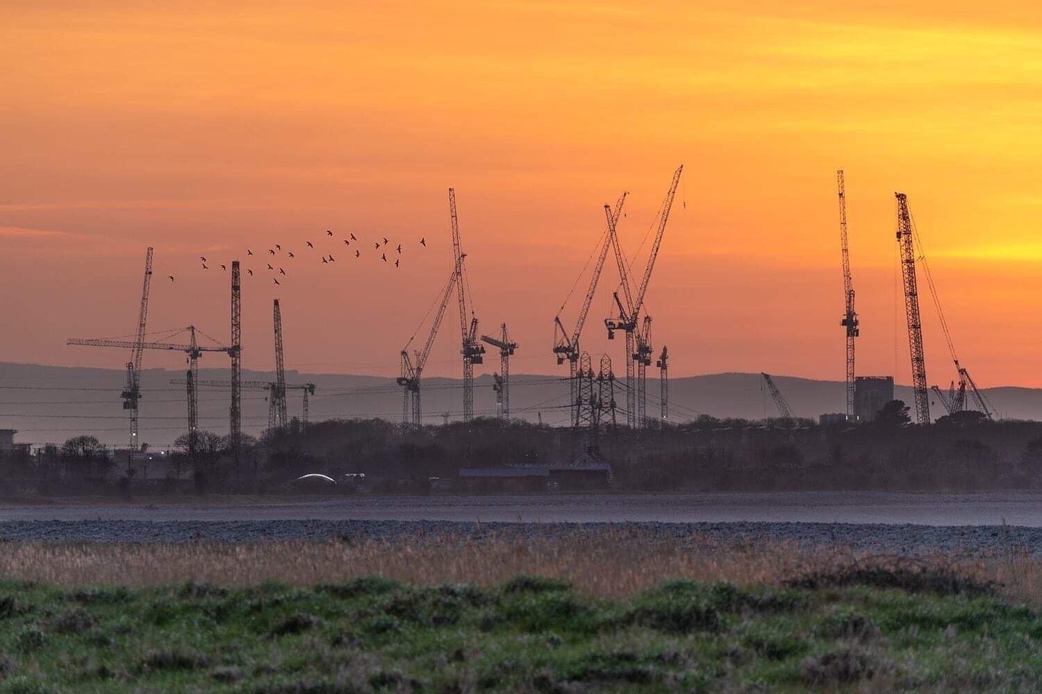 Cranes filling the horizon line as work goes on at Hinkley Point in Somerset