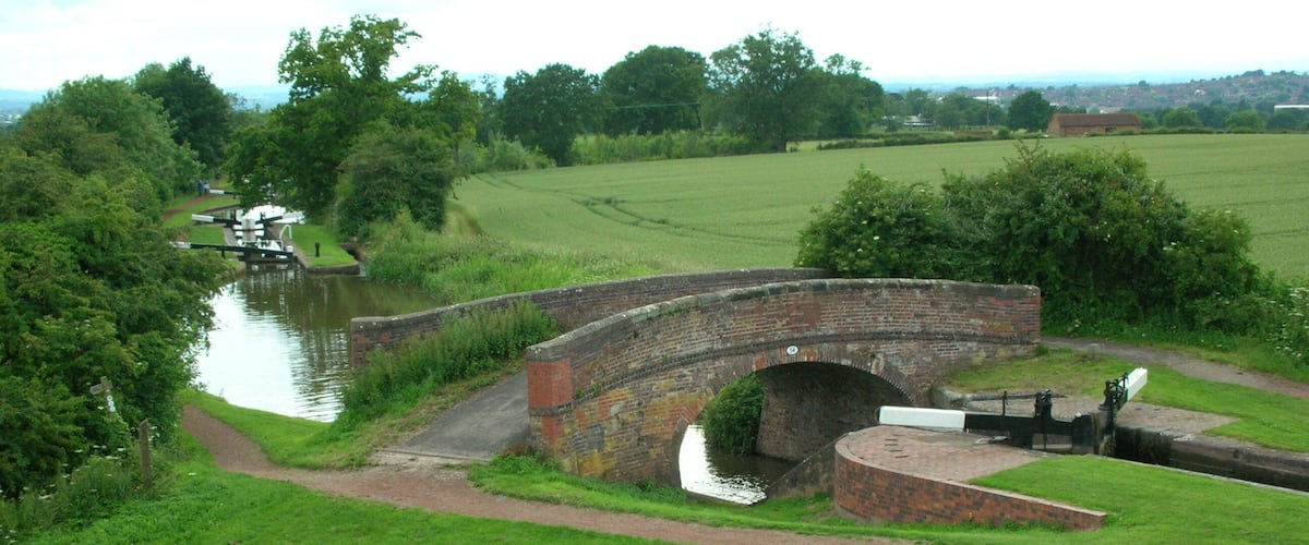 Some of the Tardebigge Locks and a bridge (number 54) on the Worcester and Birmingham Canal near Tardebigge, Worcestershire, England. Photographed from the embankment of Tardebigge Reservoir by me 24 June 2007. Oosoom