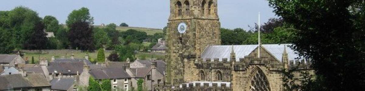 Tideswell - church and village rooftops View from sharp bend in Church Lane.