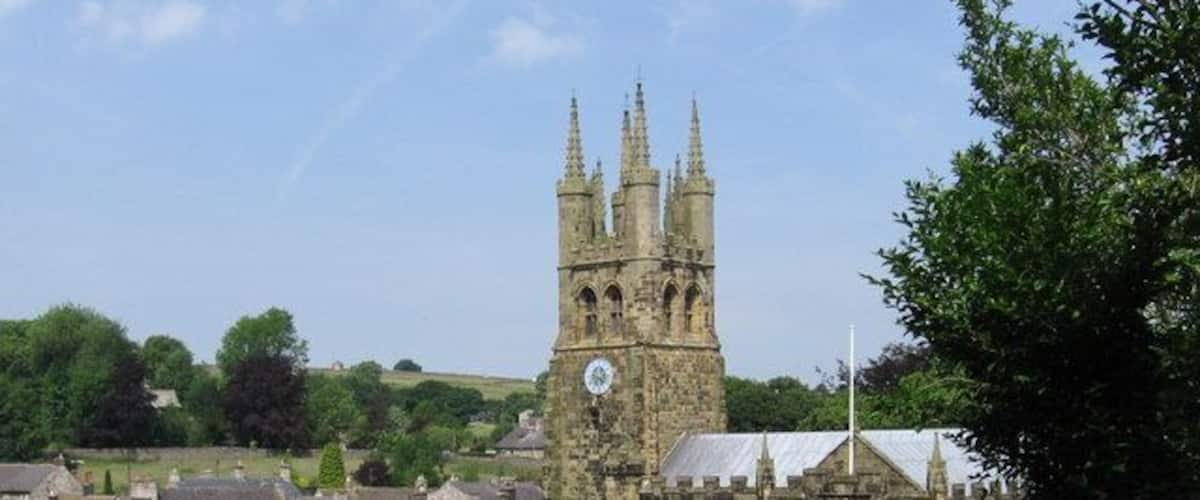 Tideswell - church and village rooftops View from sharp bend in Church Lane.