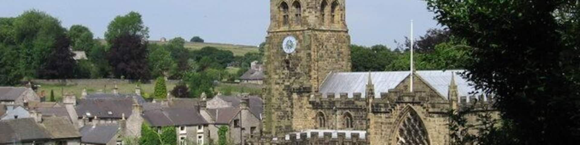 Tideswell - church and village rooftops View from sharp bend in Church Lane.