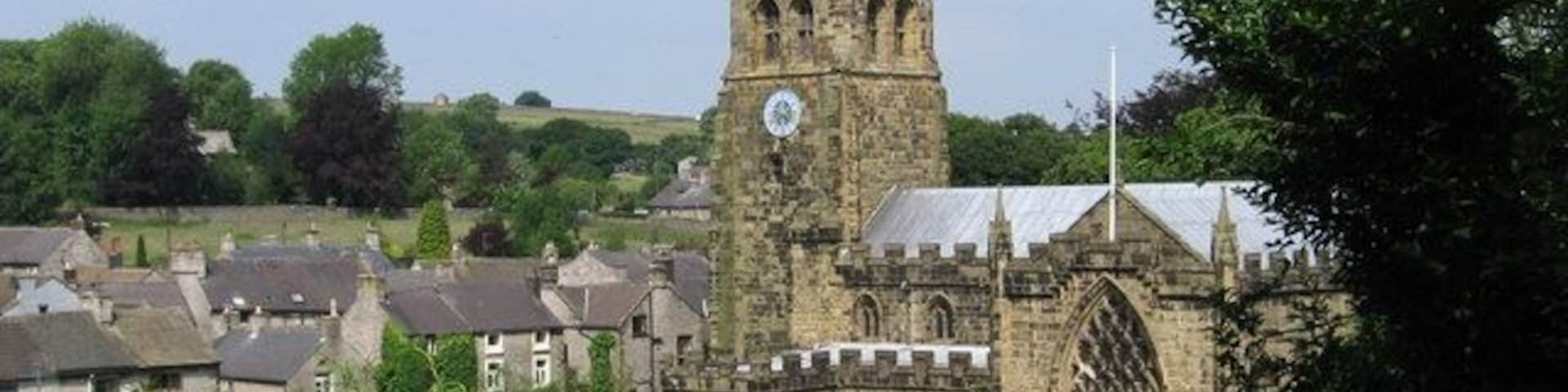 Tideswell - church and village rooftops View from sharp bend in Church Lane.