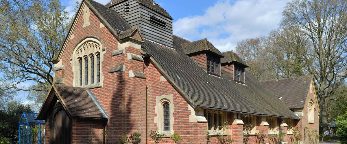A historic church with a pointed steeple and arched windows.