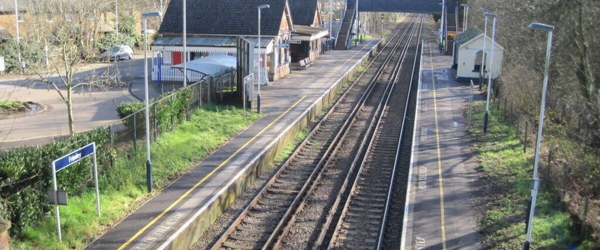 Railway tracks, a platform, and a small station building.