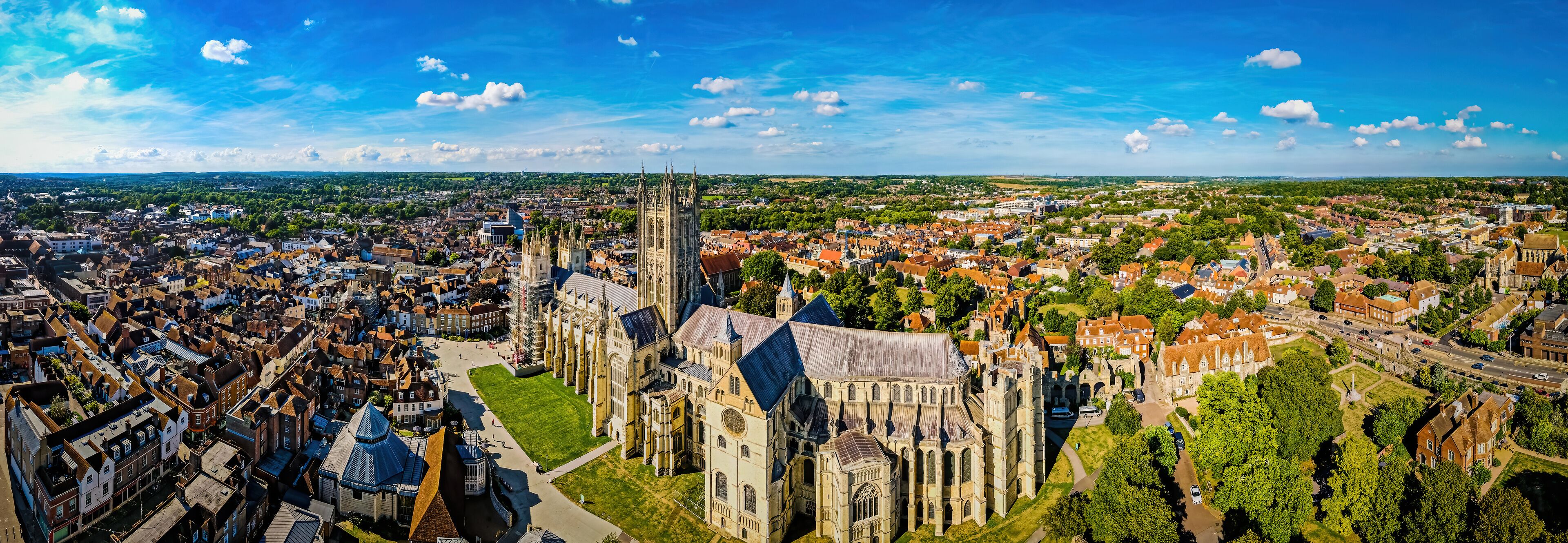 An aerial view of a historic city with a prominent cathedral and surrounding residential areas.