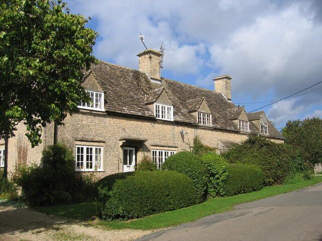 Great Rissington. Typical village cottages in the lane leading from the village green to the church.