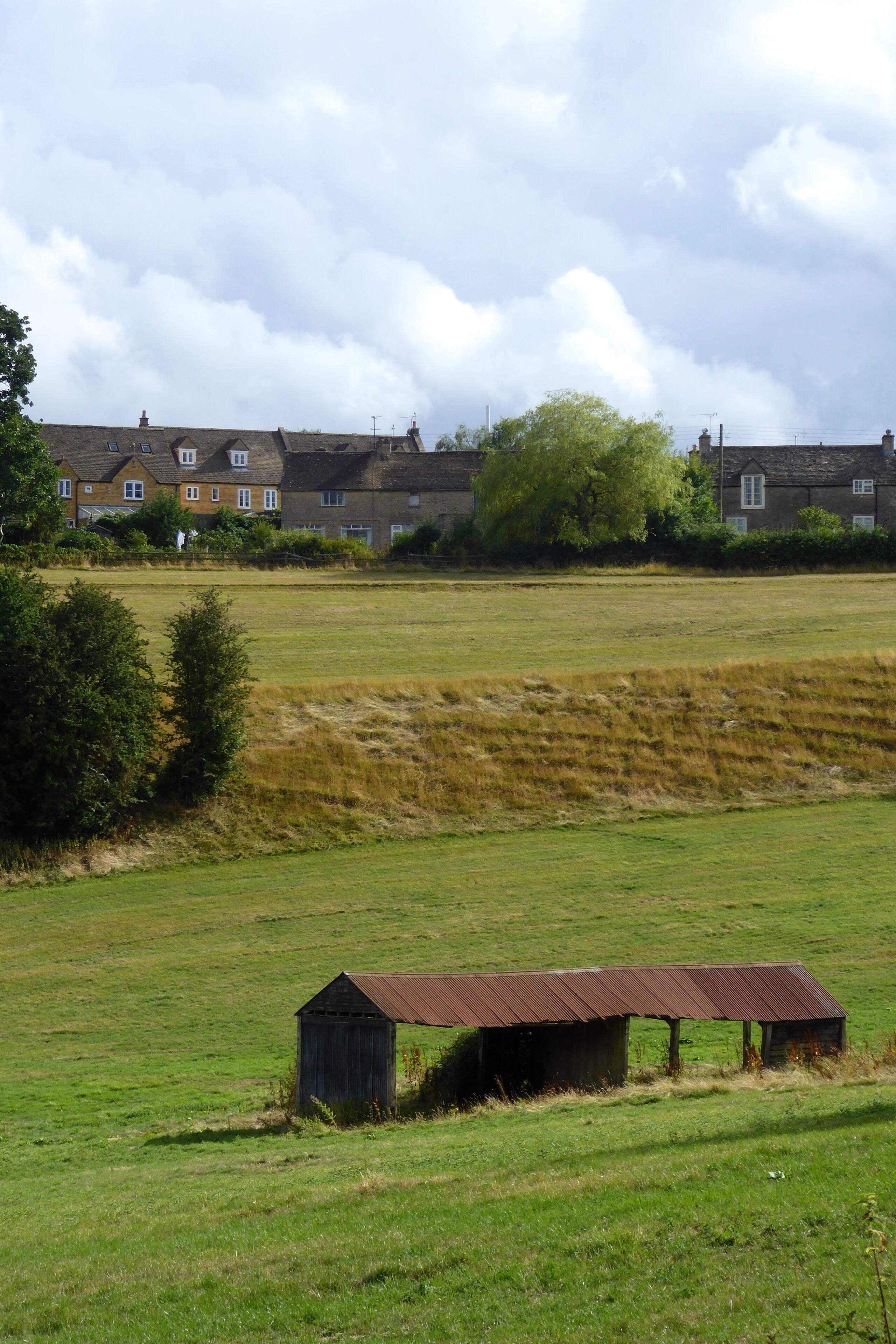 Fields and an agricultural building on the northeastern borders of Stow-on-the-Wold, Gloucestershire, as seen from Well Lane.