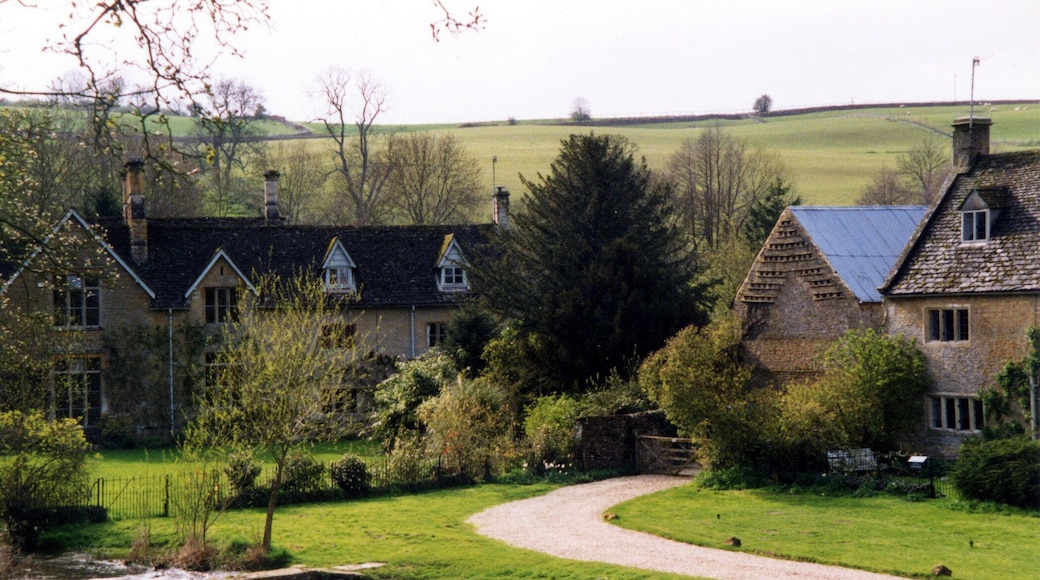 The Waysend and River Eye from the ford at Upper Slaughter. The Waysend (left to centre) is a 17th century house remodelled mid 19th century and Grade II Listed. The foot footbridge is similarly Grade II Listed probably also mid 17th century. Lower Farmhouse (right) also Grade II Listed 17th century farmhouse extended around 1700.