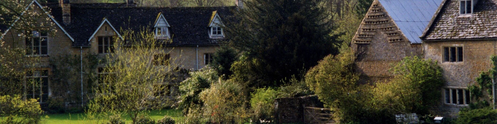 The Waysend and River Eye from the ford at Upper Slaughter. The Waysend (left to centre) is a 17th century house remodelled mid 19th century and Grade II Listed. The foot footbridge is similarly Grade II Listed probably also mid 17th century. Lower Farmhouse (right) also Grade II Listed 17th century farmhouse extended around 1700.