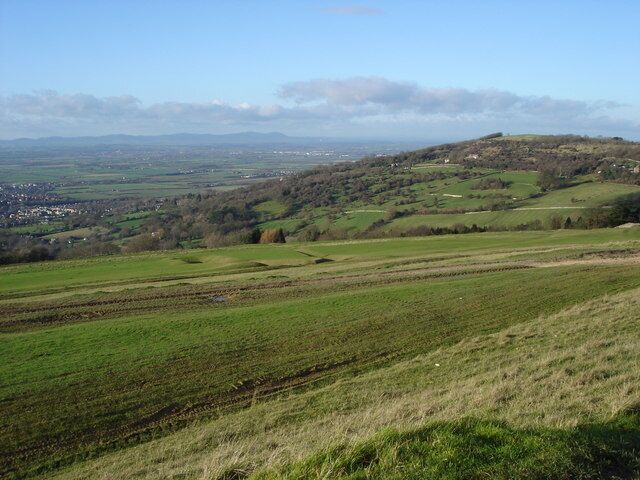 Nottingham Hill viewed from Cleeve Hill Beyond Nottingham Hill is the Severn Valley with the line of the Malvern Hills on the horizon.