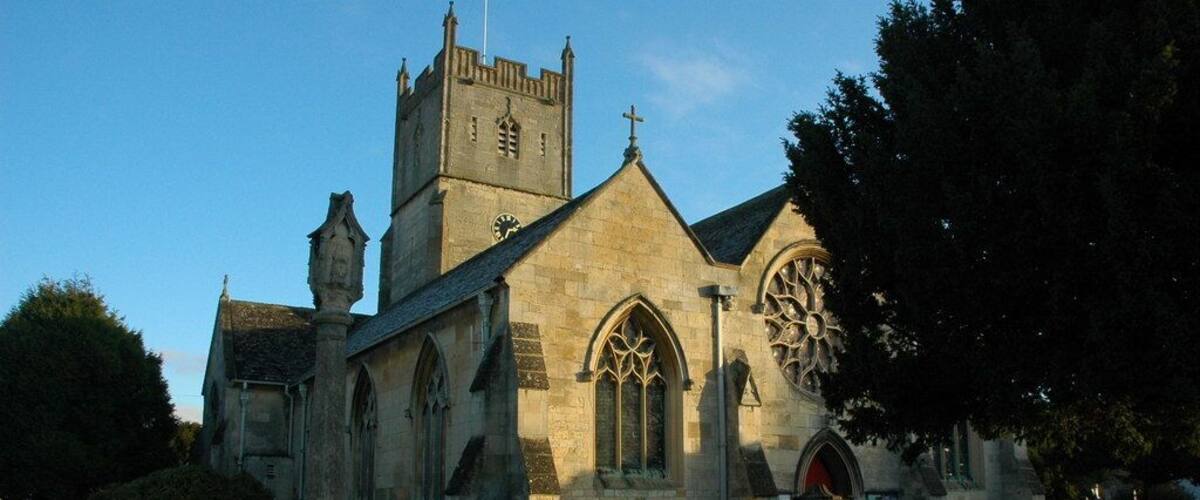 A historic church with a tall tower and arched windows.