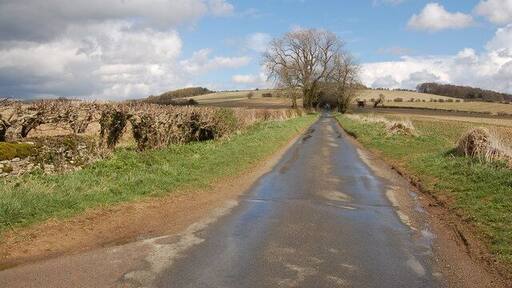 Cotswold lane near Charlton Abbots View looks eastwards as this unclassified road climbs upwards towards Roel Gate.