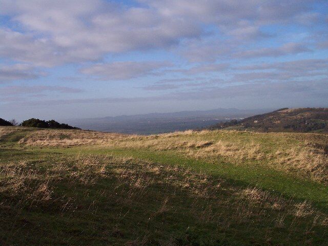 View of the Malvern Hills from Cleeve Hill. Looking WNW across the Severn Plain to the Malvern Hills on the horizon.