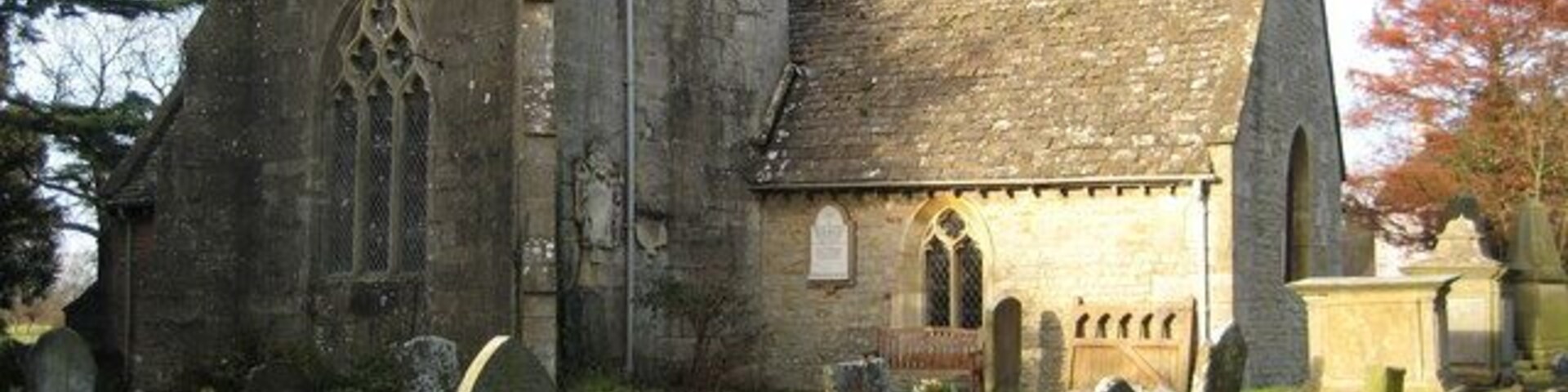 A historic church with a tower and a graveyard.