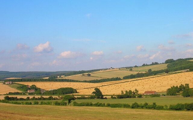 South Downs. Unnamed valley that takes the B2141 to Chilgrove. The farm to the left is Brickkiln Farm the building to the right is part of a pumping station, the slope on the right is Heathbarn Down. Taken from the bridleway that crosses the south west corner of the square.