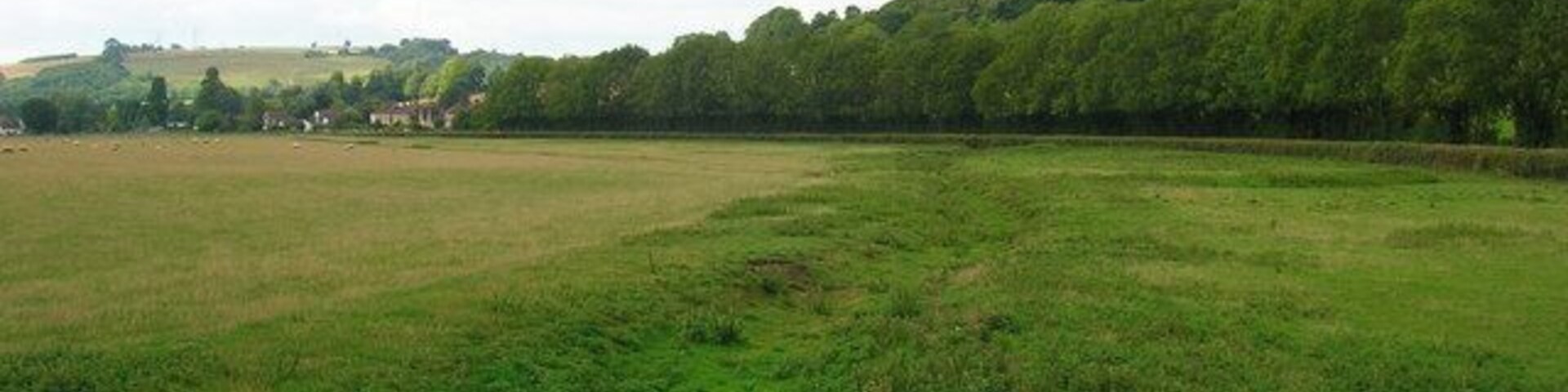 River Lavant, Charlton. Looking at the dried up bed of the river as it heads towards Singleton which can be seen in the background.