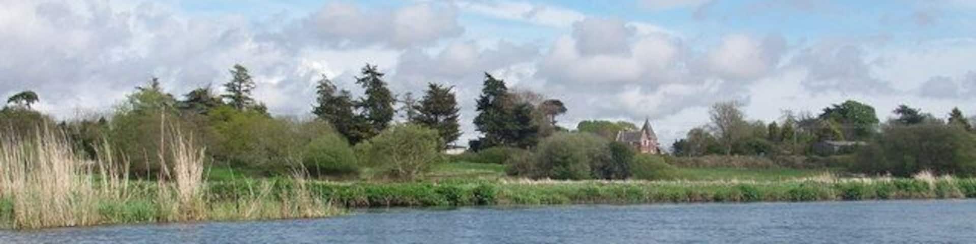 River Avon between Sopley and Winkton The gatehouse to moorlands Bible College is the building just right of centre, in this view from the river.