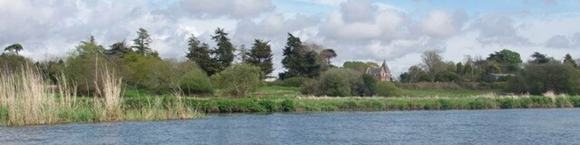 River Avon between Sopley and Winkton The gatehouse to moorlands Bible College is the building just right of centre, in this view from the river.
