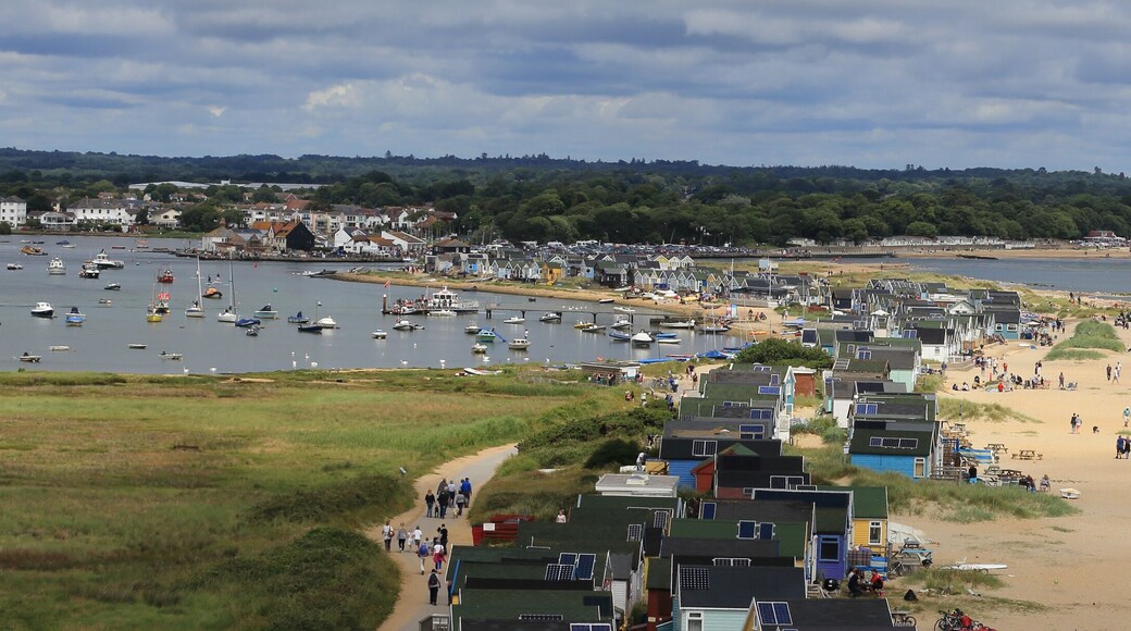 The beach and beach huts at Hengistbury Head, Christchurch Harbour, Dorset, England, UK.