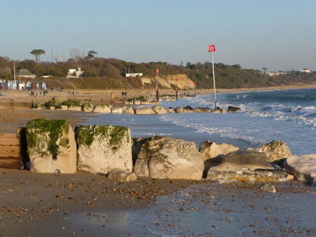 Christchurch: groynes and beacons, Friars Cliff A line of red beacons along the beach at Friars Cliff.