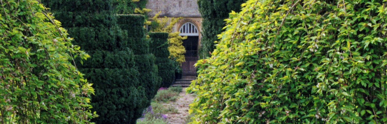 1992 Spring photograph along a path from the gardens at the east towards Barnsley House, at the time Rosemary Verey was in residence and directly caring for the garden. Processing: SLR camera Kodak Gold ASA 200-2 film negative scanned with an Epson Perfection V800 using SilverFast 8 scan program, and optimized, cropped and spun with DxO OpticsPro 10 Elite and Adobe Photoshop CS2.